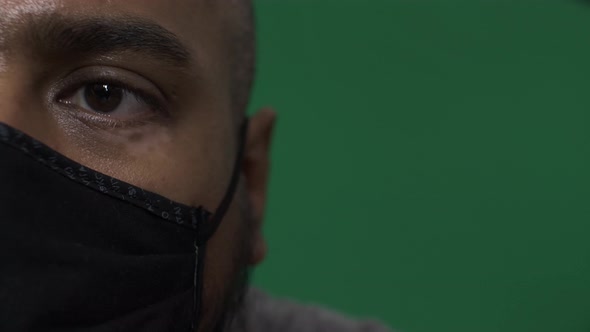 Adult Male Wearing Cotton Face Mask Indoors. Half Face Portrait, Green Screen
