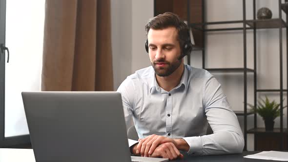 Positive Young Handsome Bearded Man Wearing Headset