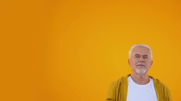 Cheerful Elderly Male Stretching Hand Up, Smiling to Camera, Success and Luck