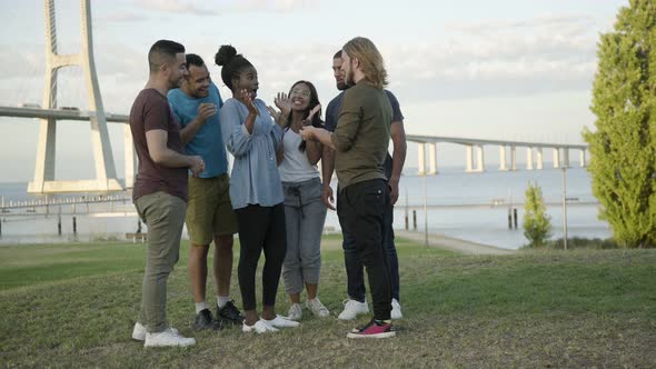 Smiling Friends Making Surprise for Young Woman