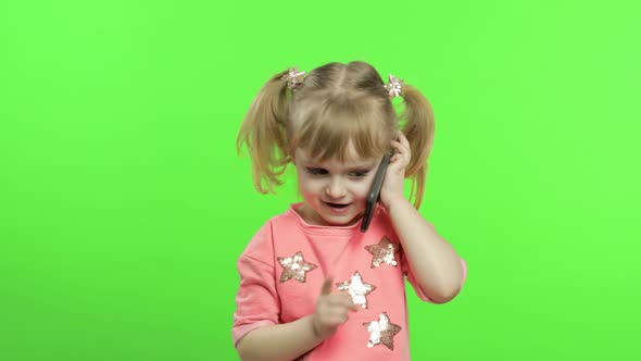 Little Girl Using Smartphone. Child Emotionally Talking on on Mobile Phone