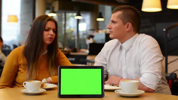 Tablet Green Screen, Happy Couple Smiles To Camera in Cafe, Coffee and Cake
