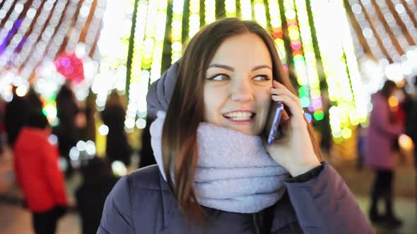 Beautiful Girl Calls Friends on New Year's Eve with Congratulations, Christmas and New Year