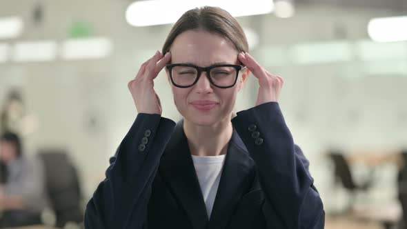 Portrait of Young Businesswoman having Headache