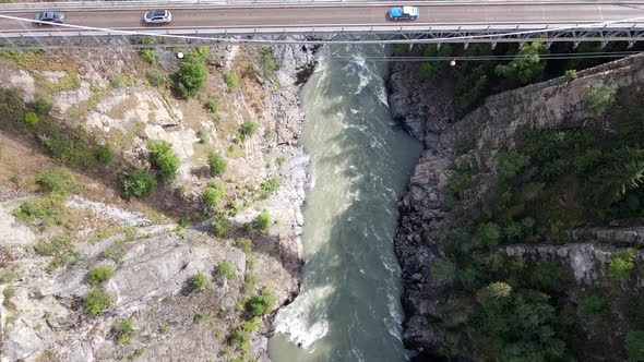 Vertical top down view of canyon with glacier river at the bottom in northern British Columbia on su