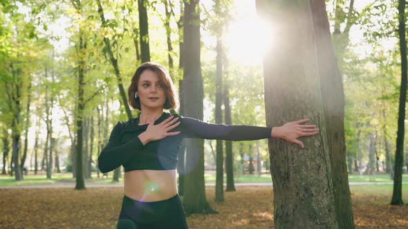 Woman Practicing Relaxing Exercises for Arms at Park