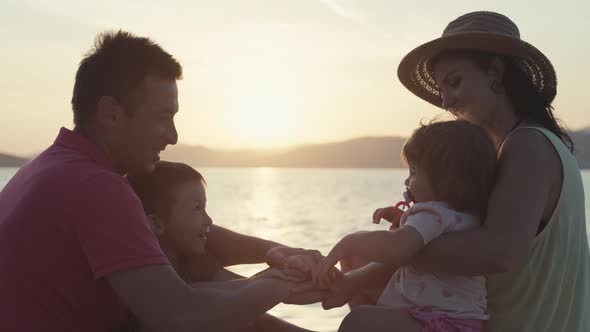 Parents and Children Fold Hand in Hand and Make a Team Cry