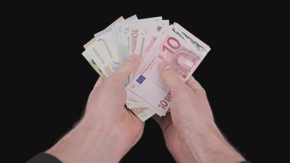 Male Hands Count a Lot of Euro Bills of Various Denominations with Alpha Channel