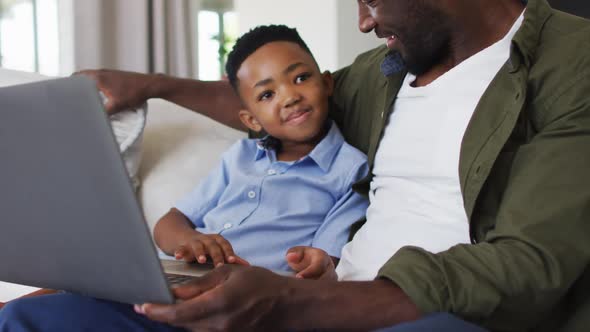 African american father and son using a laptop together