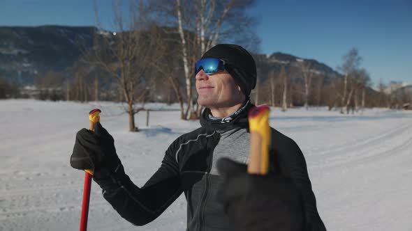 Smiling Cross Country Skier Holding Ski Poles