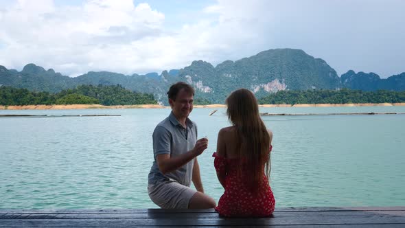 Man Doing Marriage Proposal to His Girlfriend Hug Happily Puts Engagement Ring