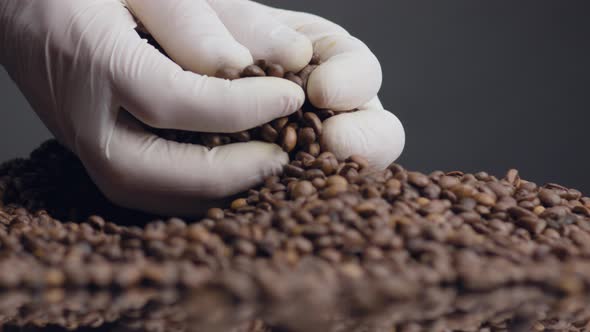 Hands Taking Fistful Coffee Beans Close Up