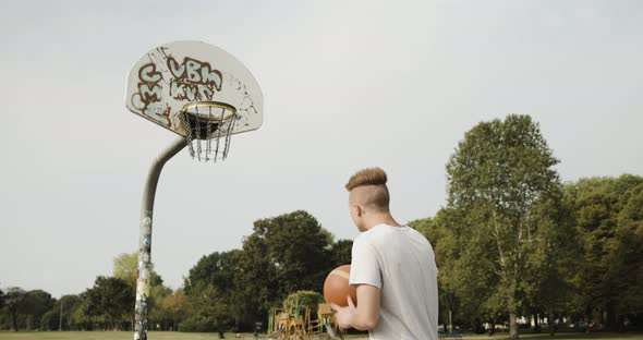 Young man on basketball court missing a strike