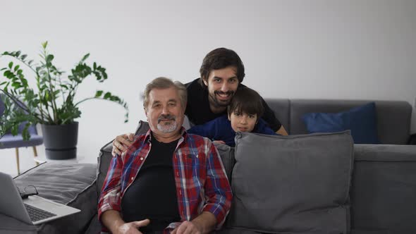 Portrait of Happy Caucasian Three Generation Men Smiling to the Camera at Home