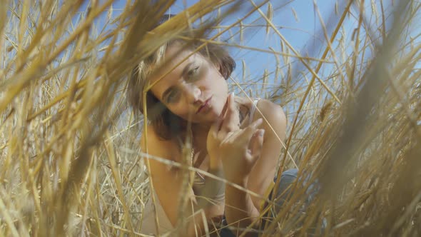 Adorable Woman with Short Hair on the Wheat Field
