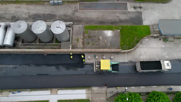 Maintenance, repair of roads. Laying of new asphalt pavement by heavy equipment