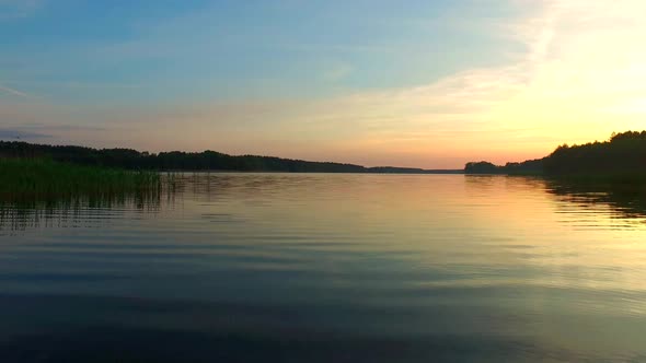 Calm sunset over the lake in the summer