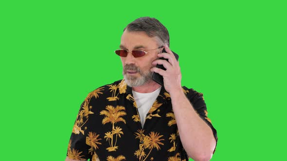 Senior Traveler in Sunglasses Walking and Making a Call on a Green Screen Chroma Key