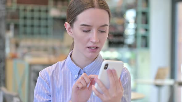 Portrait of Loss on Smartphone By Young Businesswoman