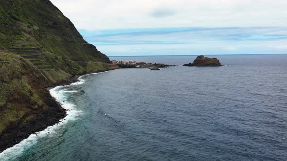 Drone hyperlapse along coastline towards Porto Moniz harbour, Madeira