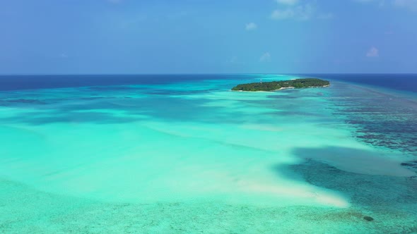 Daytime aerial abstract shot of a paradise sunny white sand beach and aqua blue water background in 