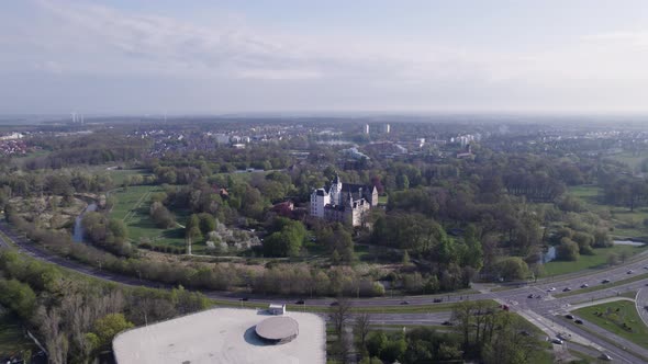 Wide view of castle Wolfsburg and highway in front of it during a sunny day