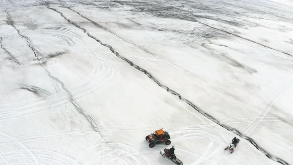 Off-road Vehicle And Snowmobiles On Langjokull Glacier In Iceland. aerial drone descend