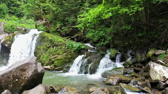 Mountain River Waterfall Flowing Between Rocky Shores in Carpathians Mountains Ukraine