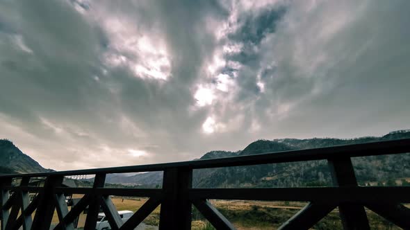 Timelapse of Wooden Fence on High Terrace at Mountain Landscape with Clouds. Horizontal Slider