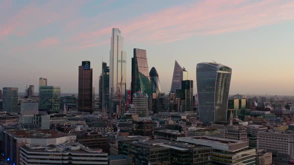 Cinematic slider aerial drone shot of City of London skyscraper buildings beautiful sunrise