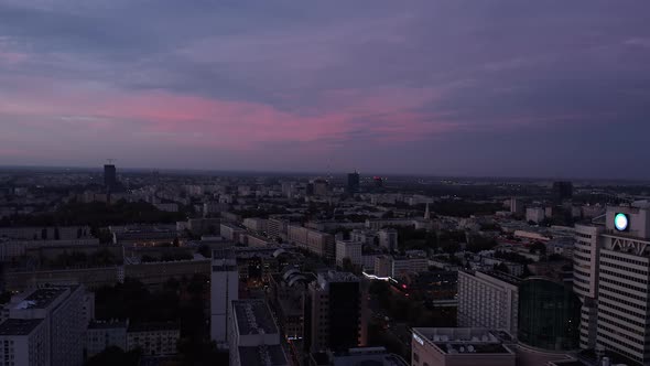 Forwards Fly Above Dimmed Urban Neighbourhood at Twilight