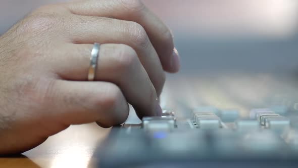 Close-up of a male hand pressing buttons on a switch board for TV production and broadcasting