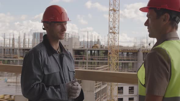 Construction Workers Talking on Site