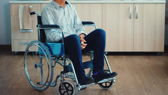 Unhappy Paralysed Senior Man in Wheelchair