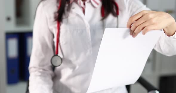 Woman Doctor Shows a Thumbs Up and Health Insurance Claim