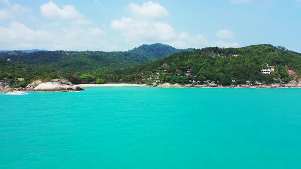 Tropical flying copy space shot of a sunshine white sandy paradise beach and aqua blue water backgro