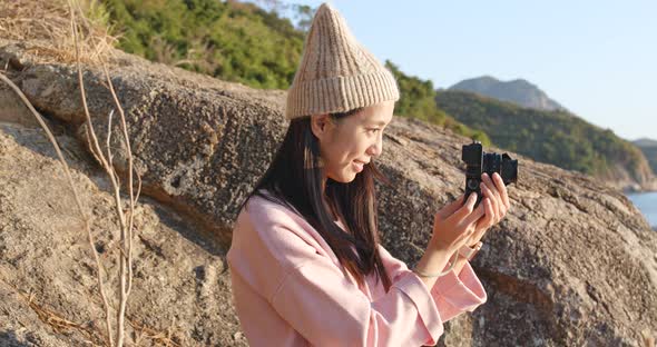 Woman taking photo on camera in the countryside