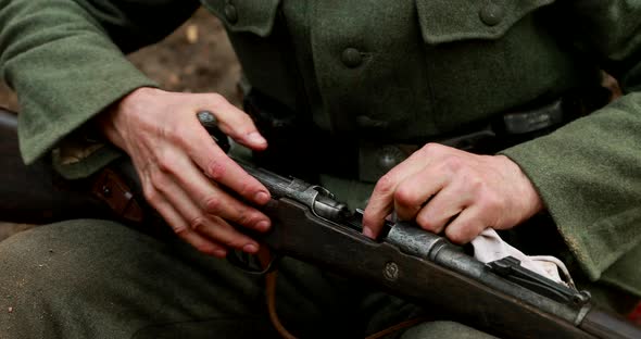 World War II German Soldier Cleaning Rifle