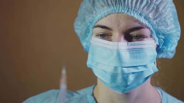 Woman Doctor Preparing Syringe for Injection