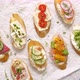 Variety of Small Sandwiches with Cream Cheese Vegetables and Salami - VideoHive Item for Sale