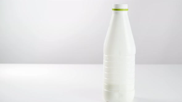 Dairy Product In A Plastic Bottle On A White Background, Yogurt In A Glass Beaker. Kefir. Milk