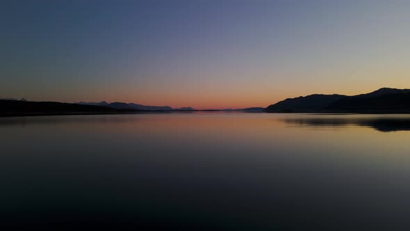 Silhouetted Mountains Against Sunset Sky On Senja Island, Norway. Aerial Drone