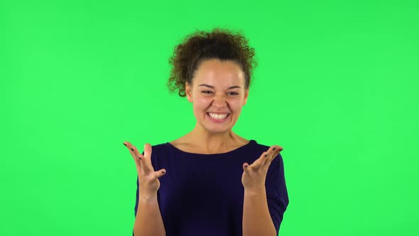Portrait of Curly Woman Indignantly Talking To Someone, Looking at the Camera. Green Screen