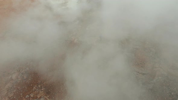 Drone Over Man Walking In Volcanic Landscape