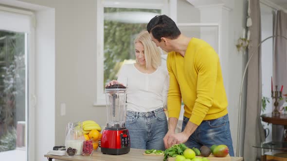 Charming Young Caucasian Wife Flirting with Confident Middle Eastern Husband Preparing Healthy