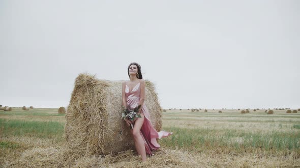 Natural Beauty of Elegant Lady Holds a Bouquet of Flowers and Poses at Haystack