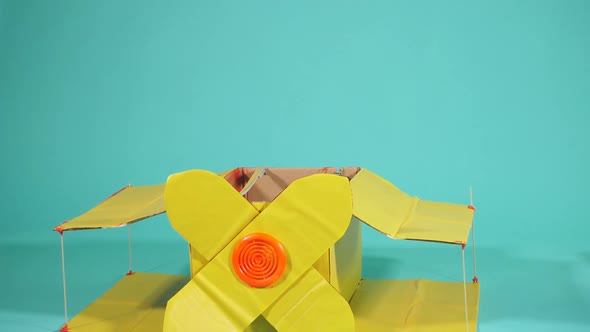 Nice Small Boy Wearing Yellow Toy Plane Stand Isolated in Blue