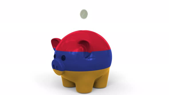 Coins Fall Into Piggy Bank Painted with Flag of Armenia alt
