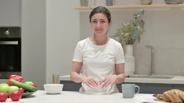 Indian Woman Making Heart Shape By Hands While in Kitchen