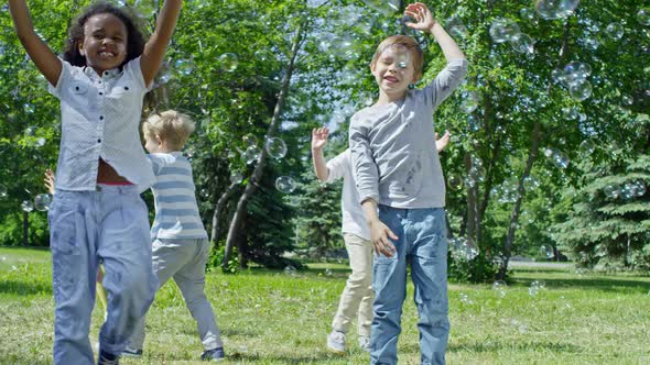 Group of Kids Bursting Soap Bubbles alt